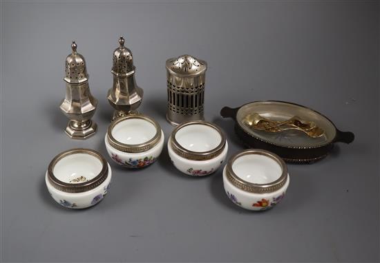 Three silver condiments, four white metal mounted ceramic salts with spoons and a mounted dish.